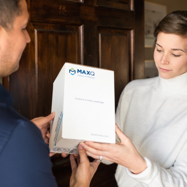 Delivery of MaxQ PharmPack to a woman by a delivery person